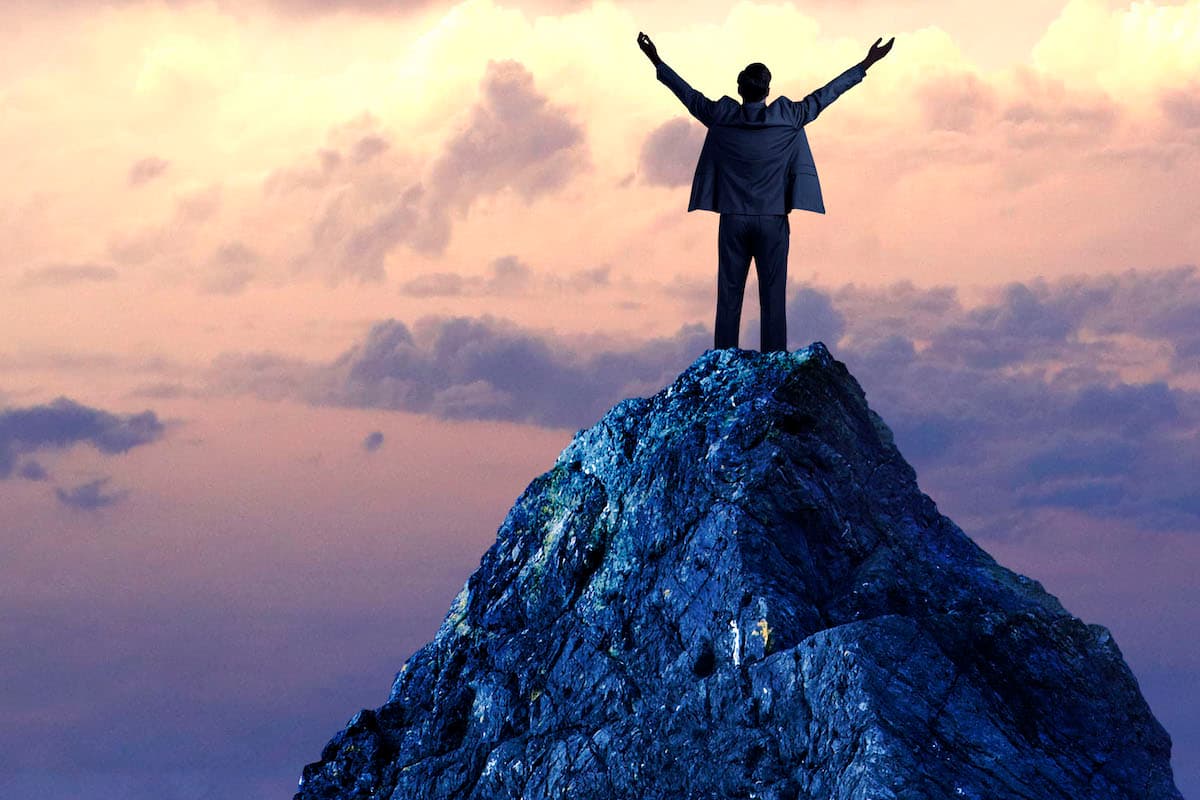 Data-Backed Ways to Crush Your Sales Goals - Person standing on a mountain