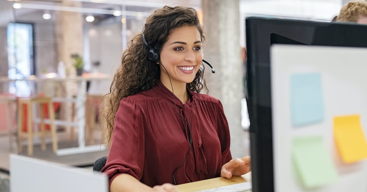 Seller makes a sales prospecting call in front of her computer