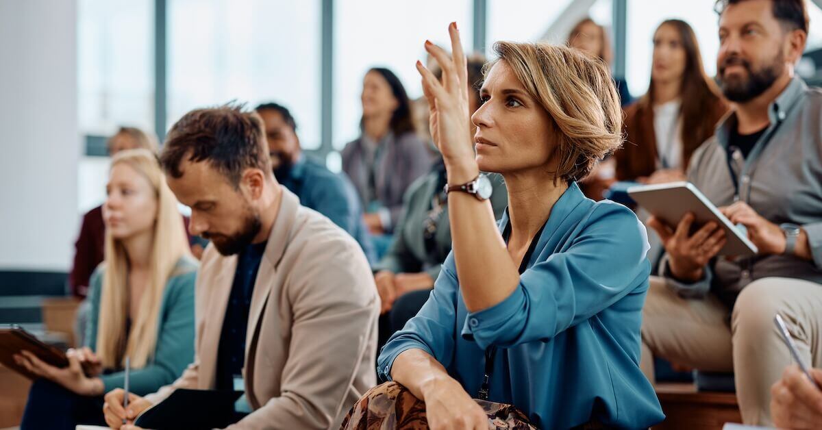 A seller raises a question during a live sales training session.