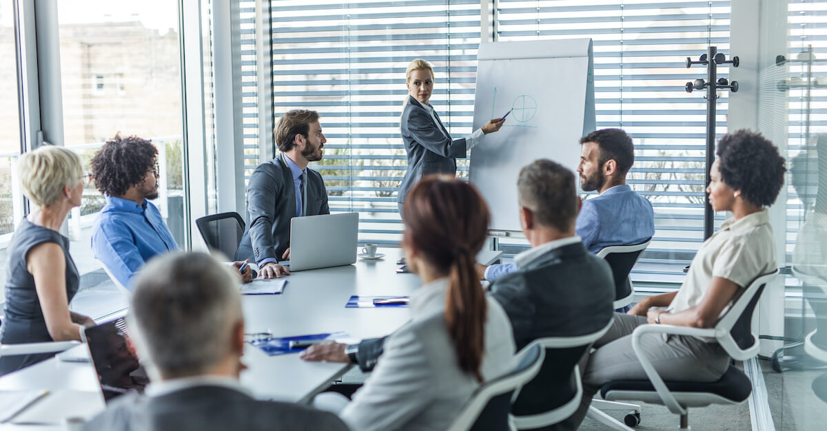 A sales training instructor greets her audience.
