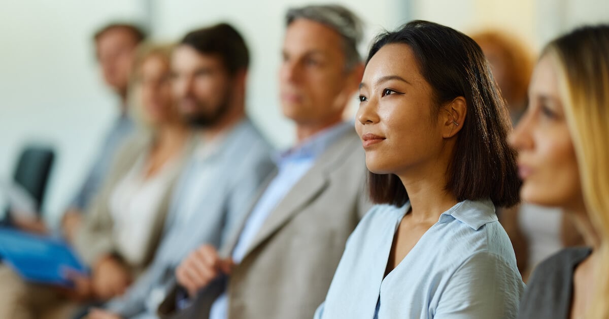 Sales training cohort listens to a presenter