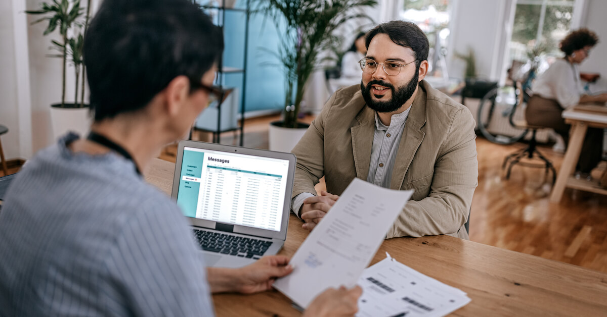 A prospective seller sits with a recruiter to participate in a sales interview.